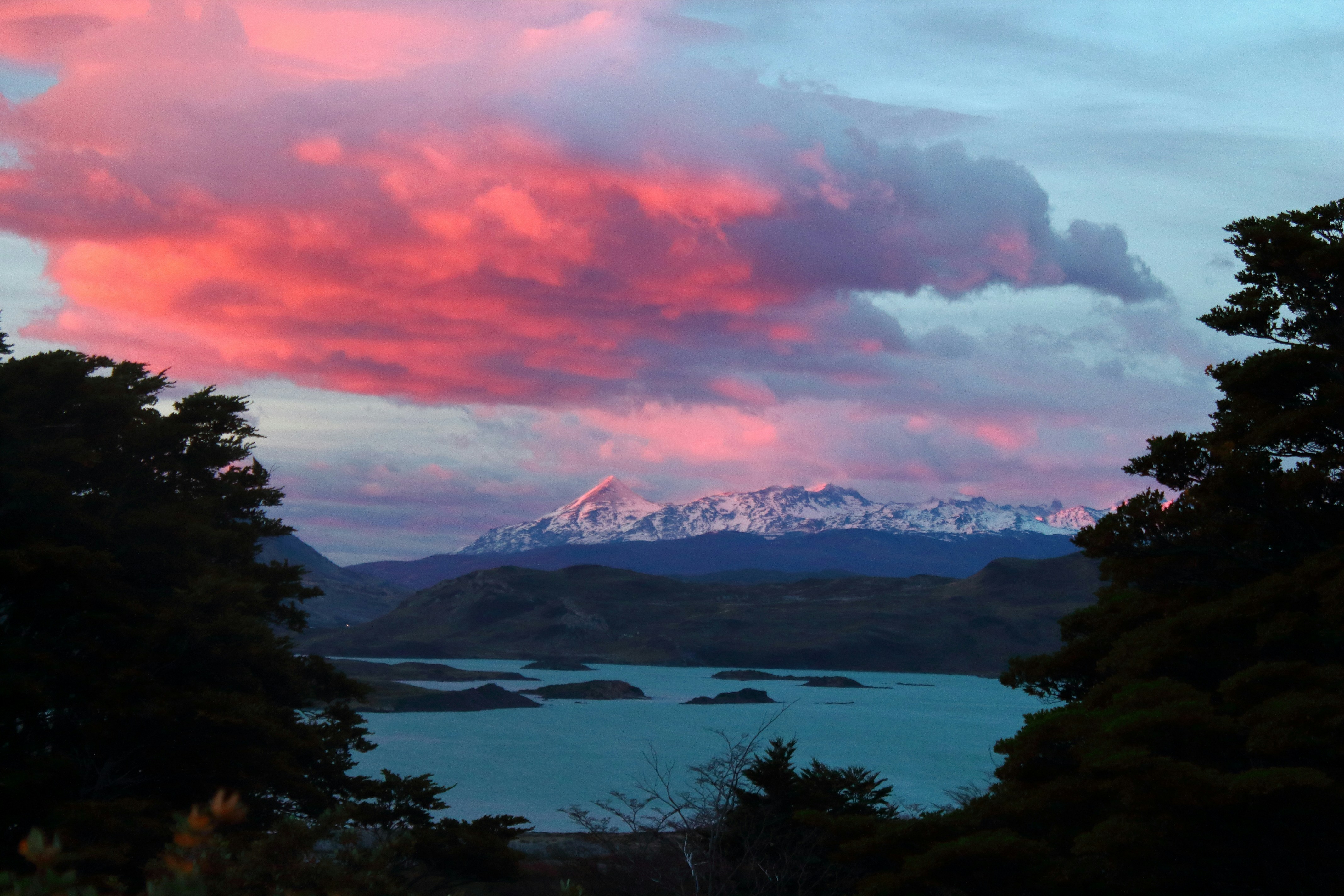a body of water with a mountain in the distance