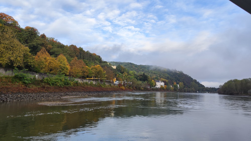 a body of water with trees and hills around it