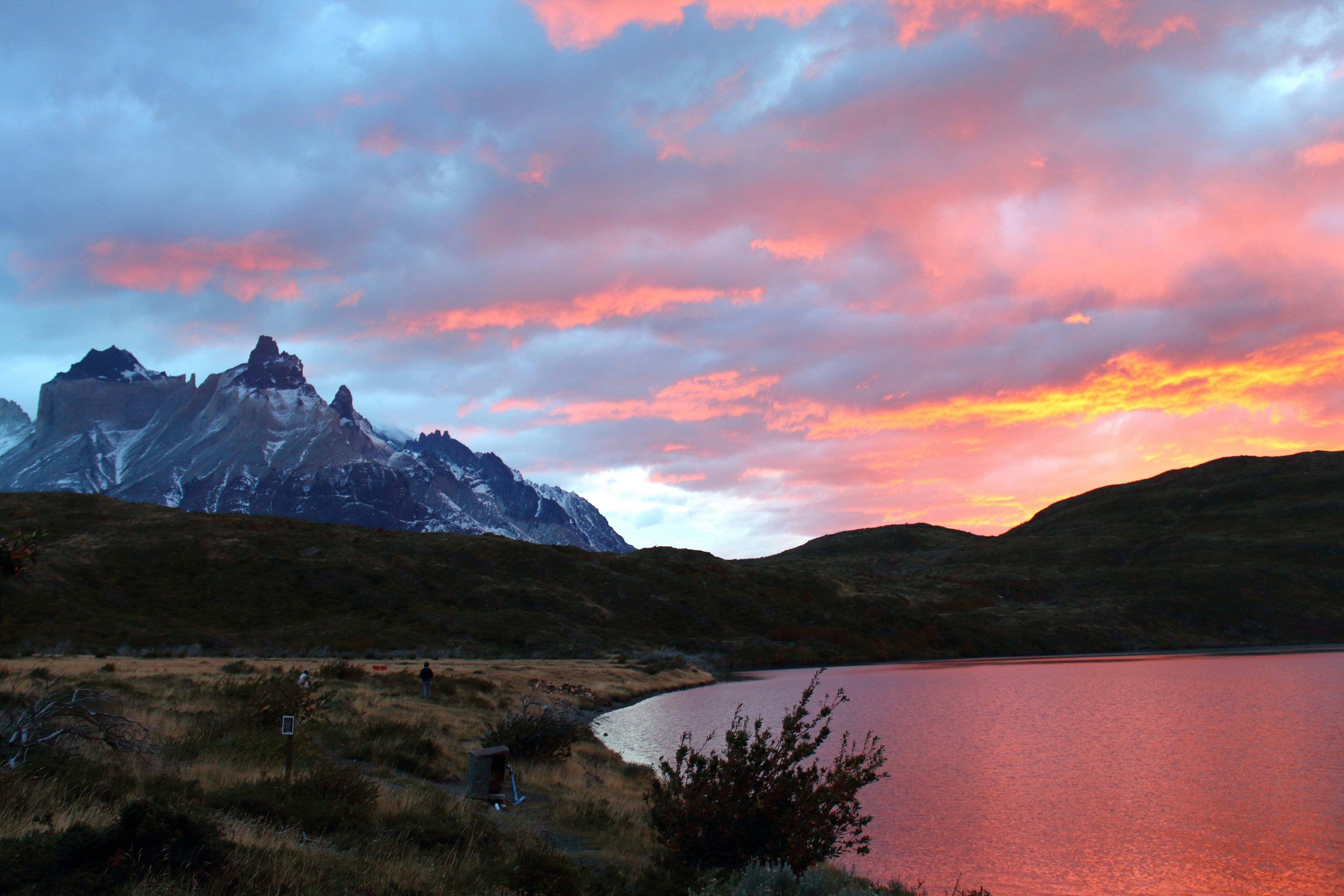a body of water with mountains in the background