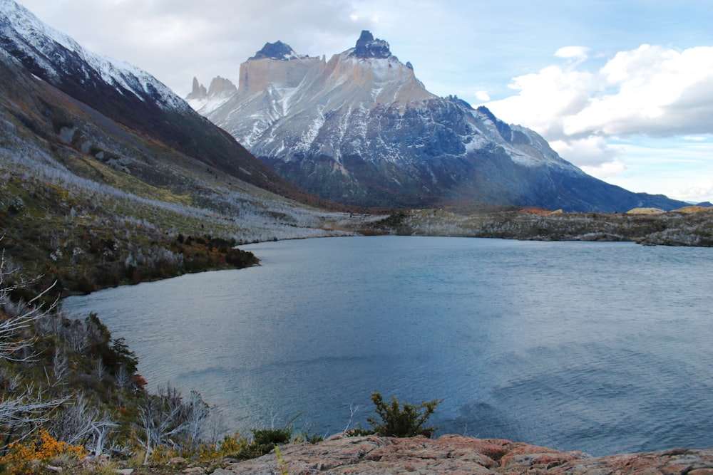 a lake with mountains in the background