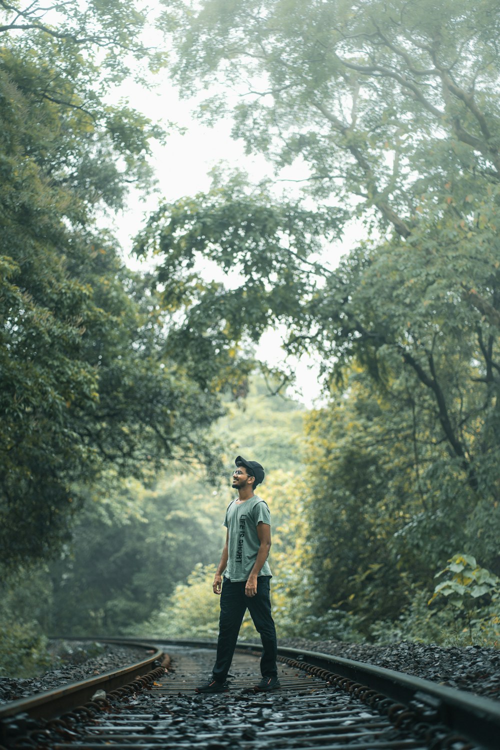 a man standing on a railroad track