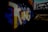 Large, colorful graffiti art spelling 'KING' in bold letters on a brick wall, set in a dimly lit underpass or tunnel with a nearby bridge structure visible in silhouette.