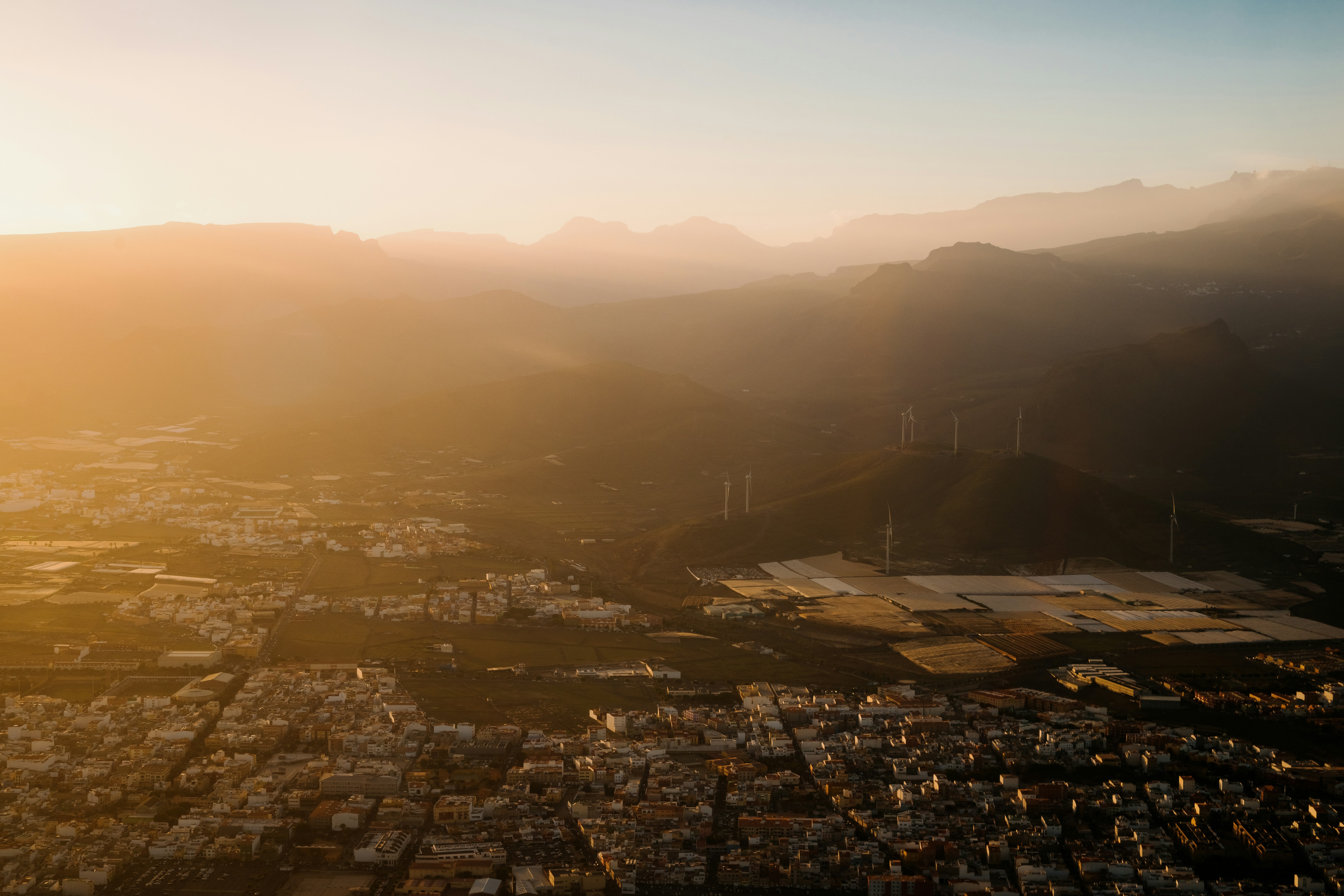 Aerial view of wind turbines at golden hour