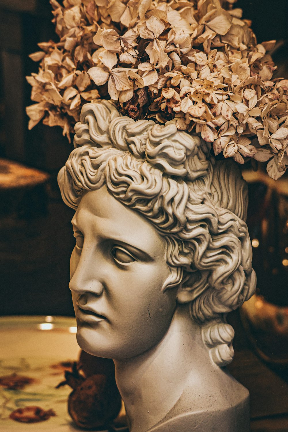a statue of a person with flowers on the head