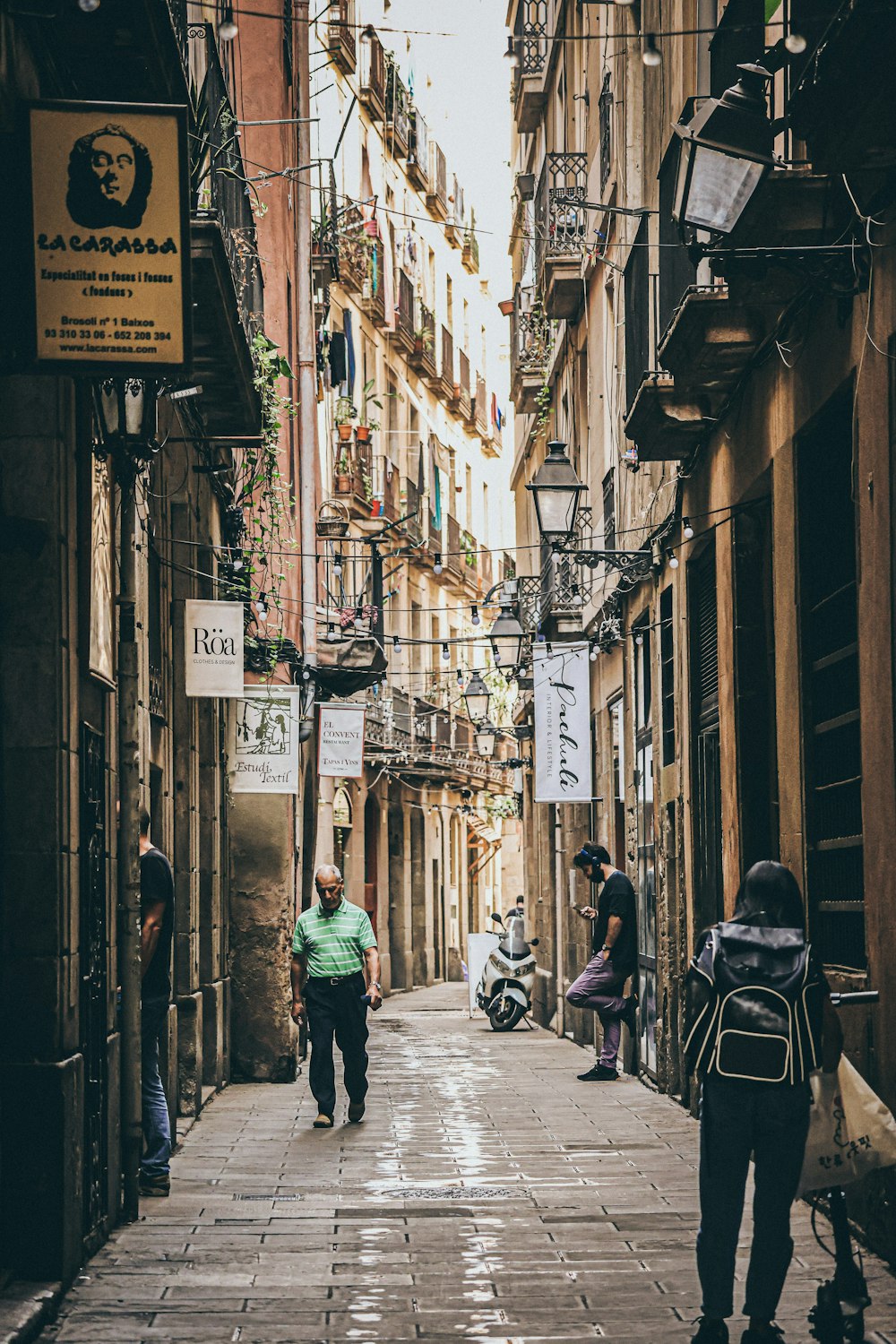 people walking down a narrow street