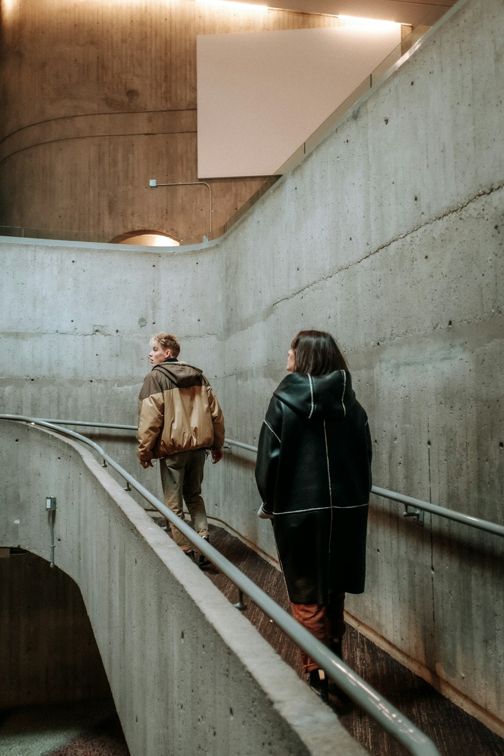 a man and woman walking down a flight of stairs