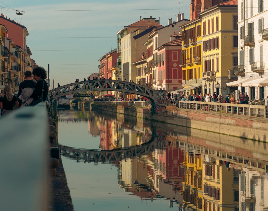 a bridge over a body of water with buildings around it,