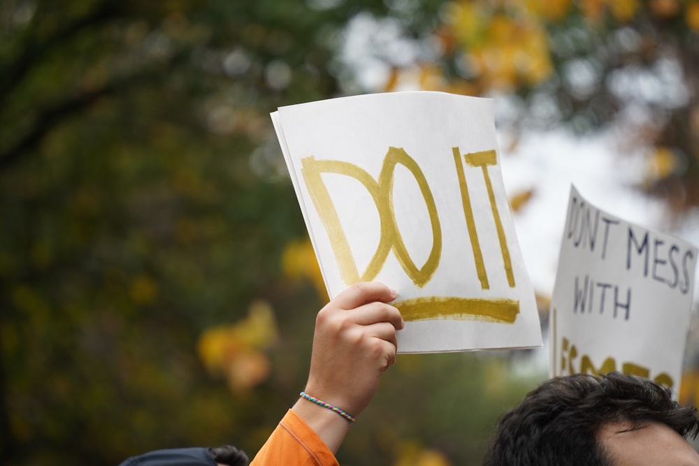 a person holding signs