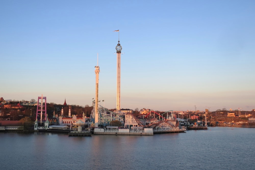 a bridge over a body of water with a tower in the background