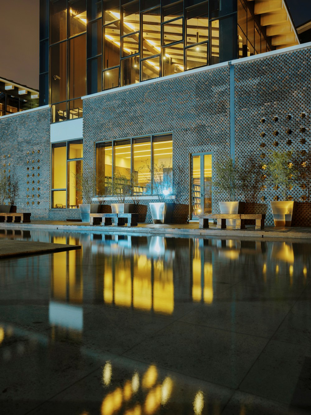 a building with a pool and tables