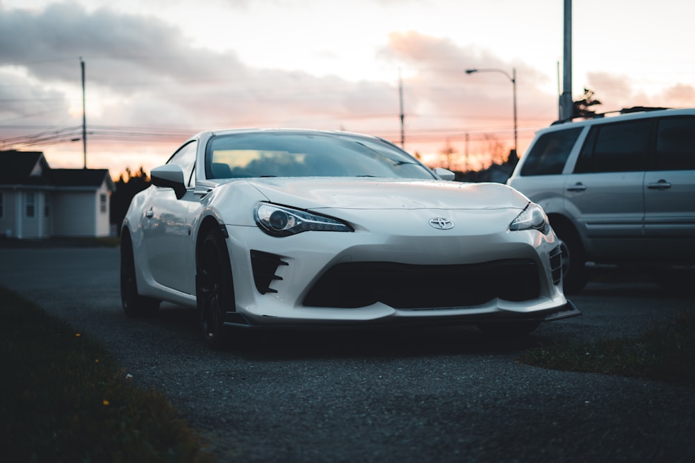 a white sports car parked on a street