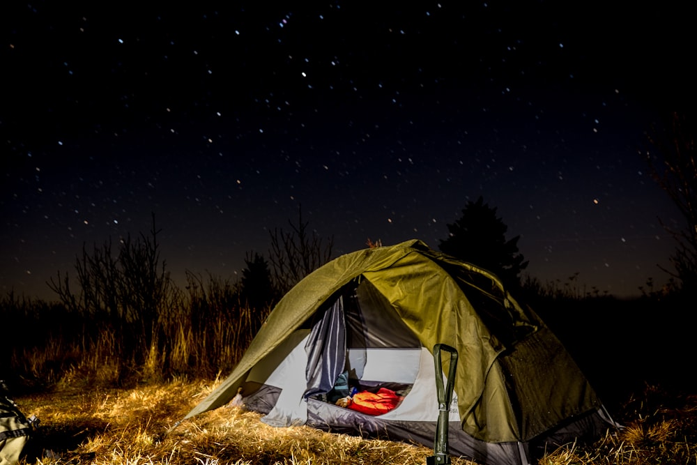 a person lying in a tent at night