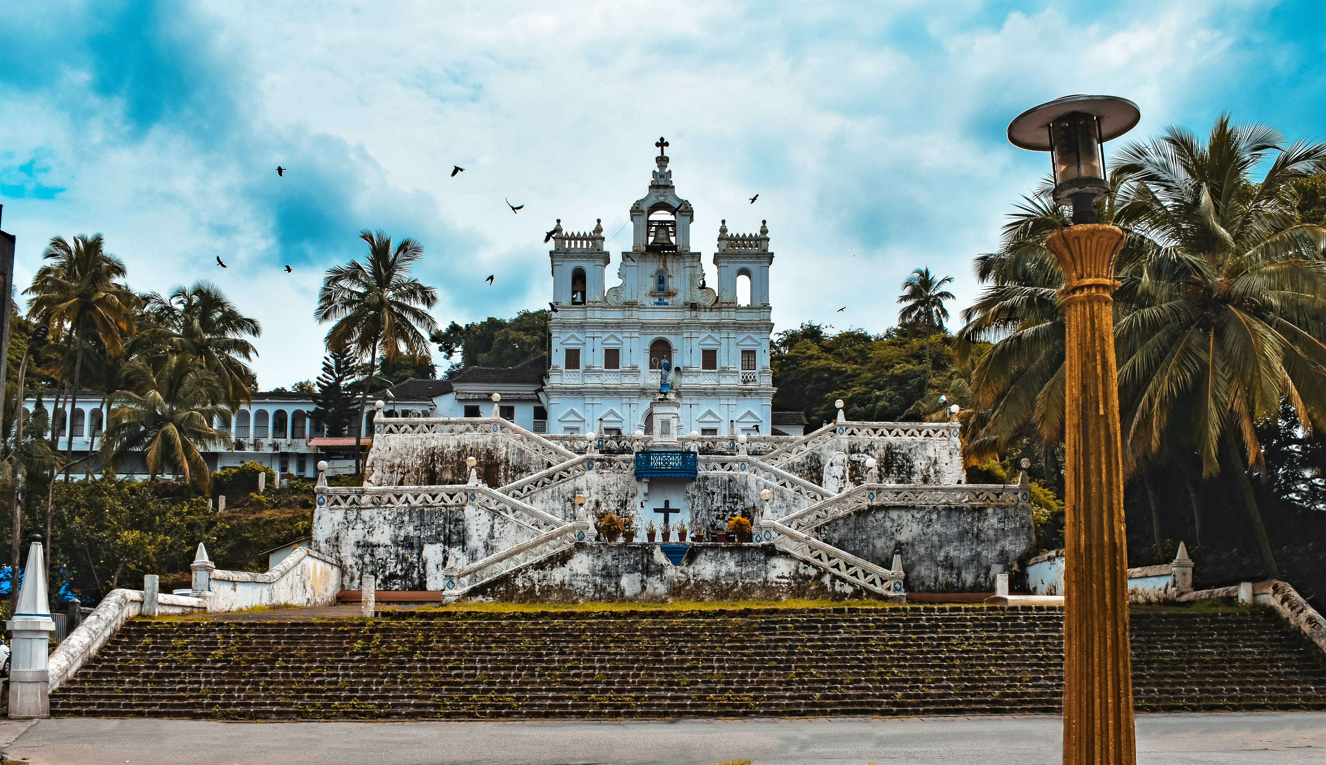 A wide shot of the Basilica of Bom Jesus in Old Goa, symbolizing the historical and religious significance of the site.