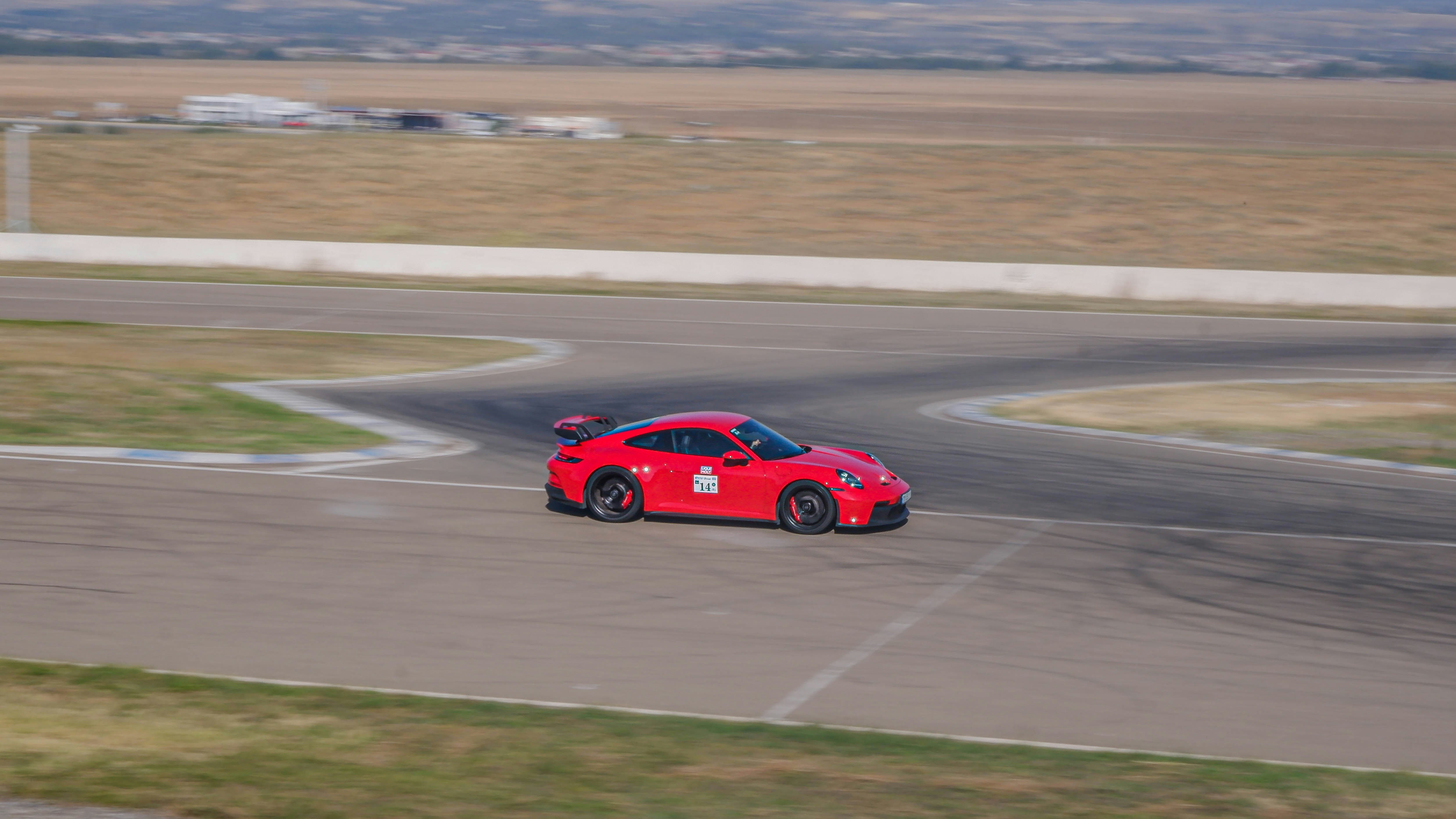 A red car on a race track photo – Free Rustavi Image on Unsplash