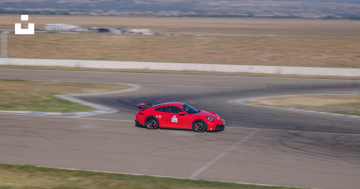 A red car on a race track photo – Free Rustavi Image on Unsplash