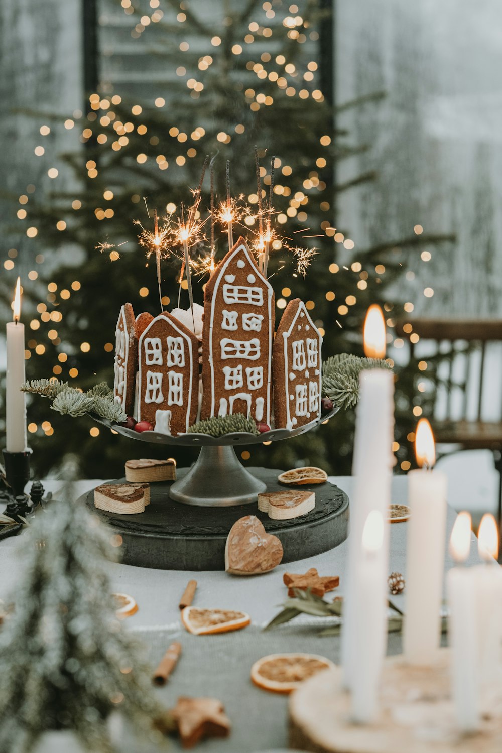 a decorated tree with candles and a sign