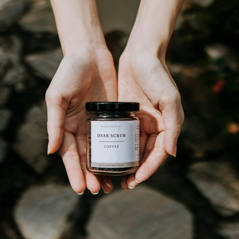 a person holding a jar