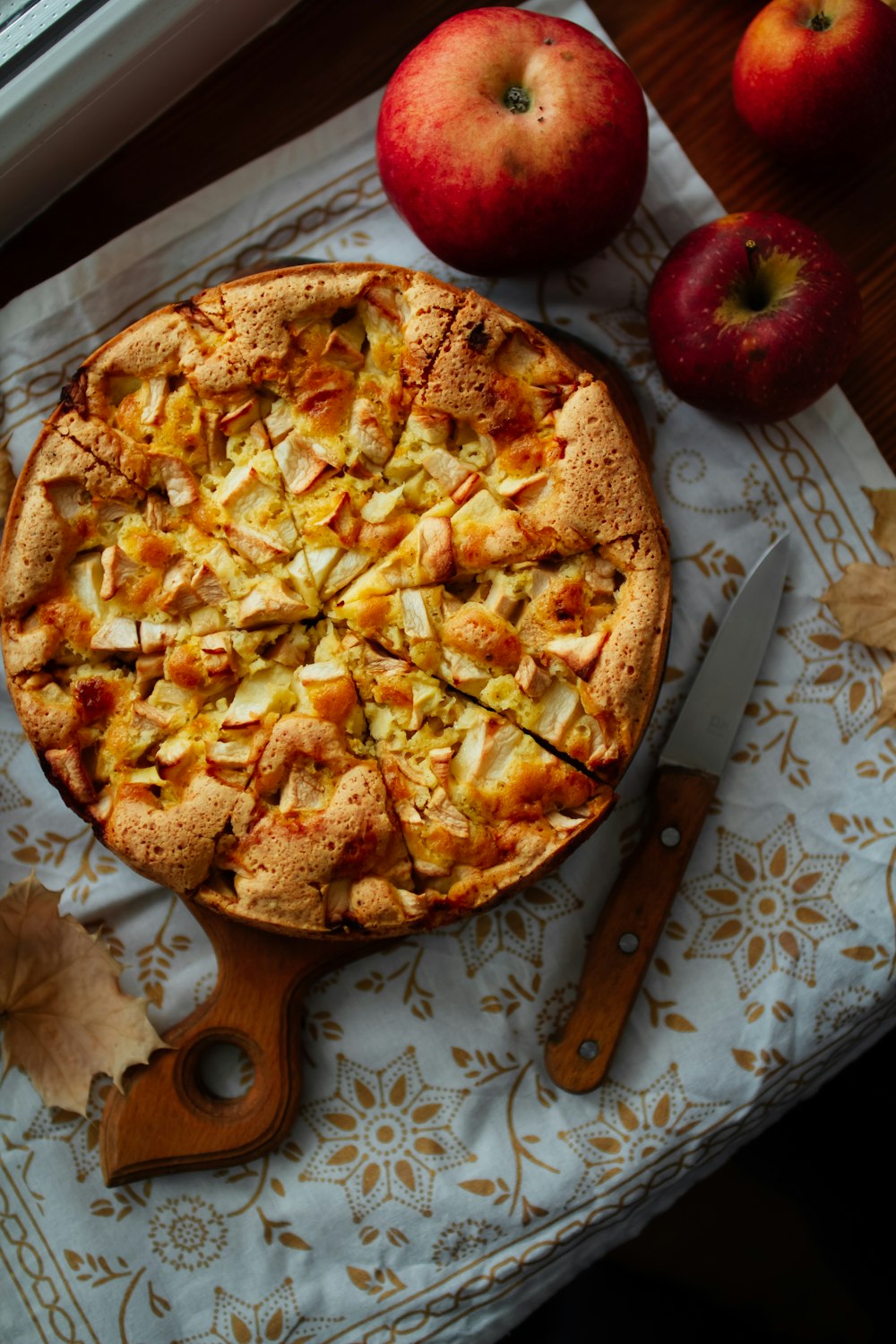 a pie with apples on the side