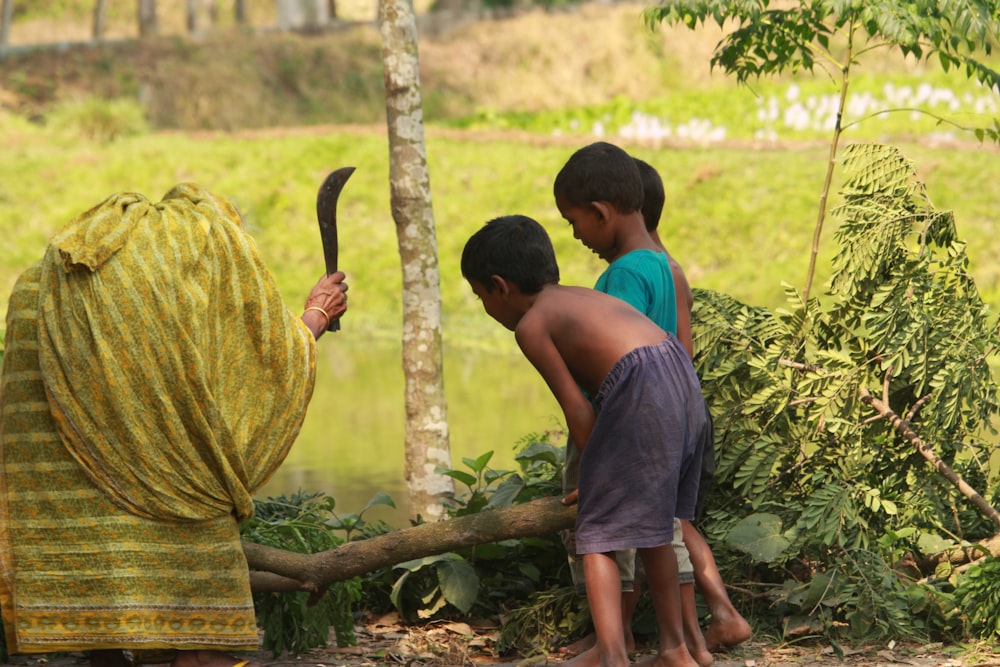 a couple of boys playing with a large net in a forest