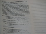 A close-up of a page from a book, specifically a biblical text from Ecclesiastes, featuring text highlighted with verse numbers. The text discusses philosophical reflections on life and human existence.