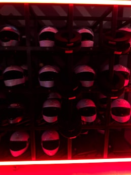Display of professional firefighting helmets and gear arranged on a sleek black surface with red lighting accents.