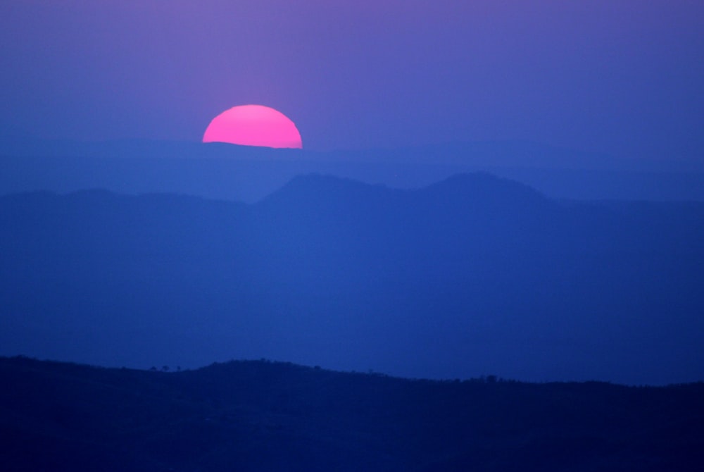 a sunset over a mountain