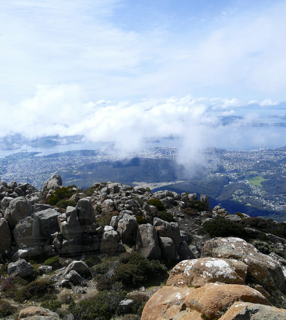 a rocky area with a body of water in the background