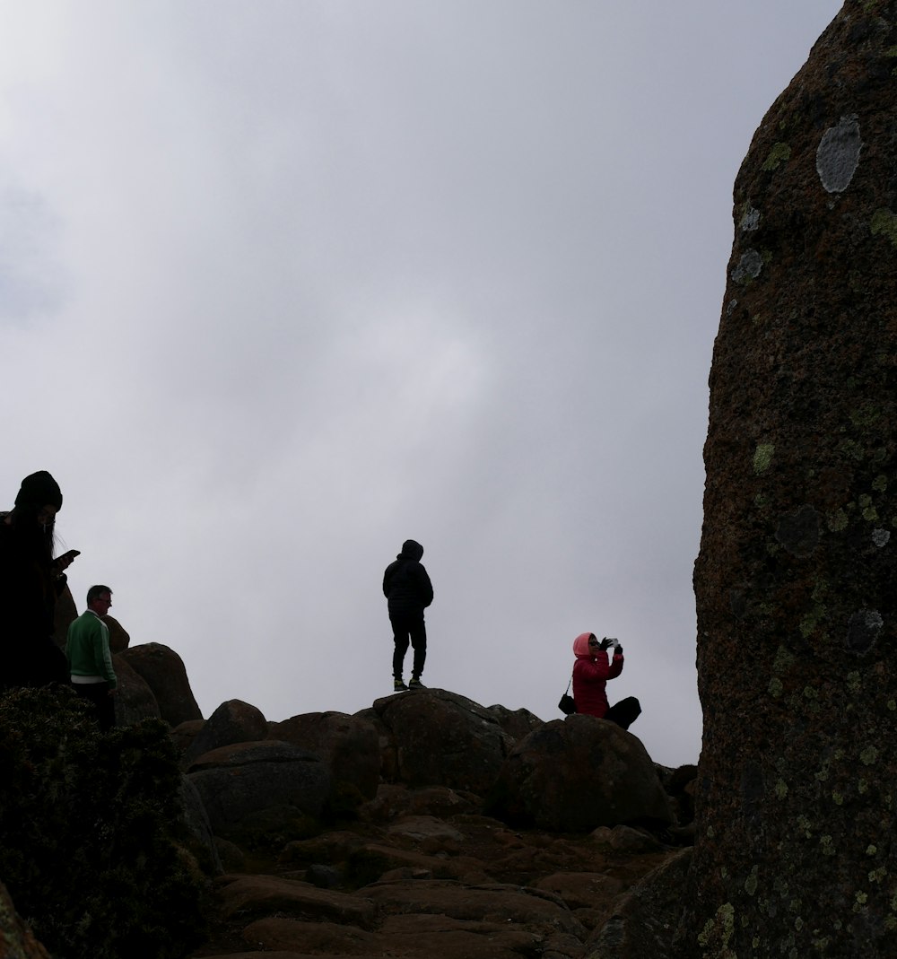 a group of people on a rocky hill