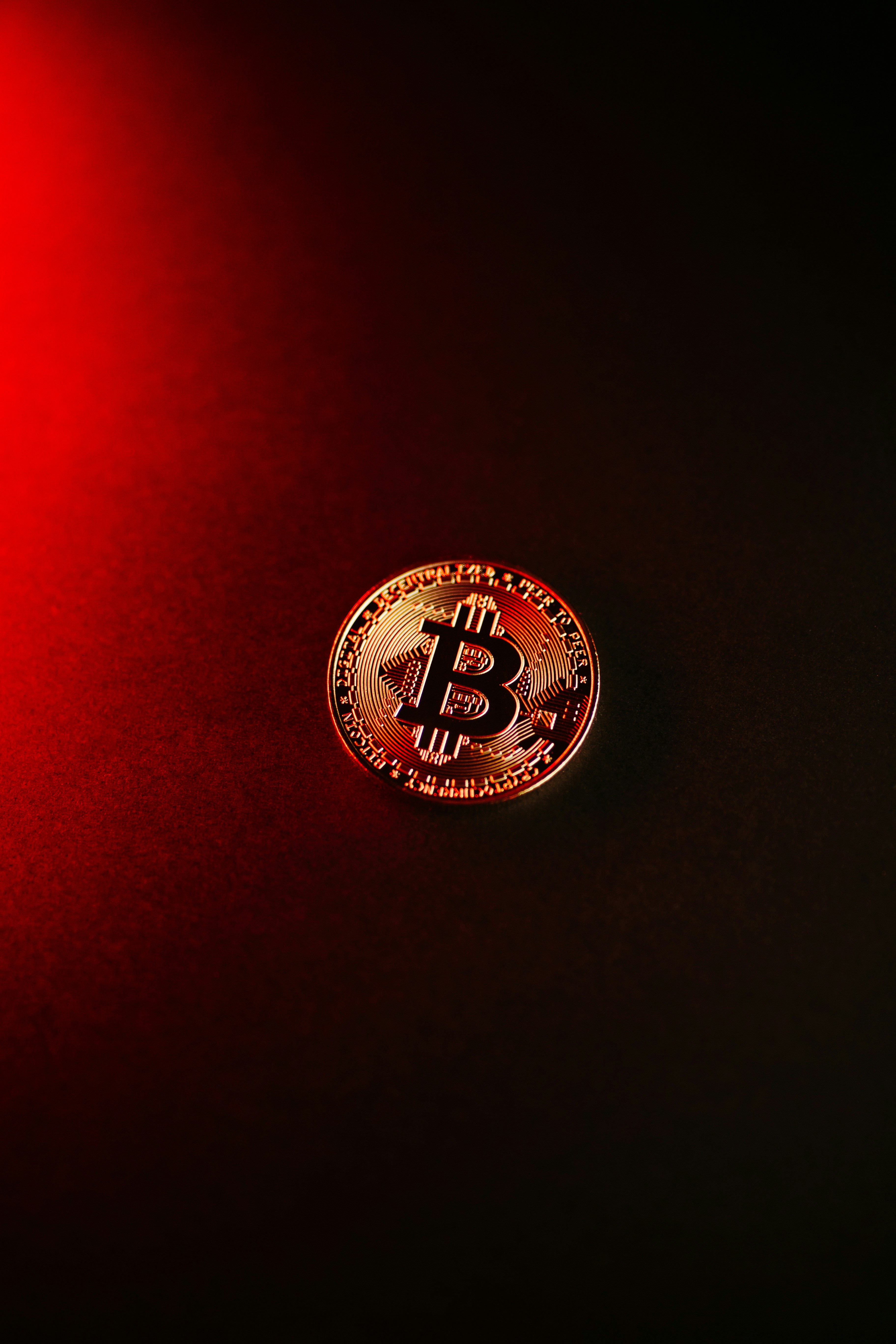 Bitcoin cryptocurrency coin on a dark background, symbolizing investment opportunities and risks in the crypto realm.