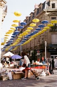 people sitting on a bench under umbrellas