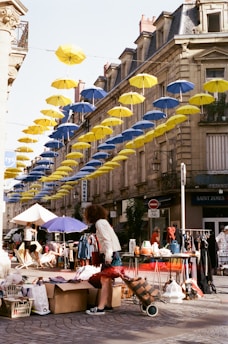 people sitting on a bench under umbrellas