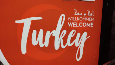A welcoming office entrance with signage in Turkish and English.