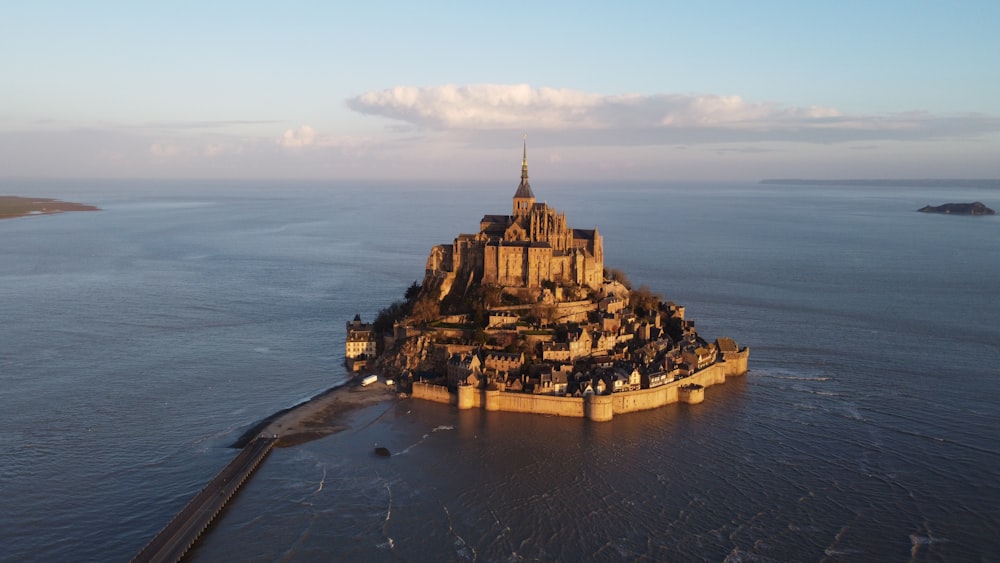 a castle on a small island with Mont Saint-Michel in the background