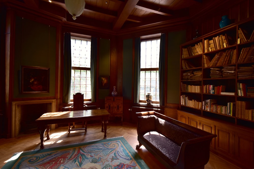 a room with a table and bookshelves