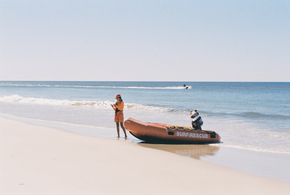 a woman and a man on a boat on a beach