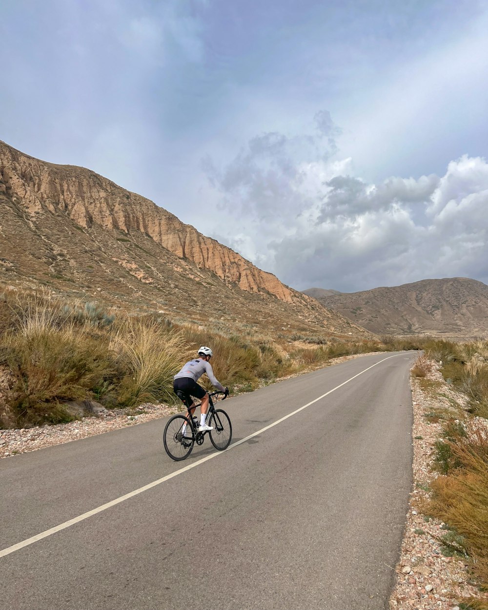 a person riding a bicycle on a road