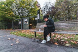Chase sitting on a park bench sharing sushi with the swifty bird beside him.