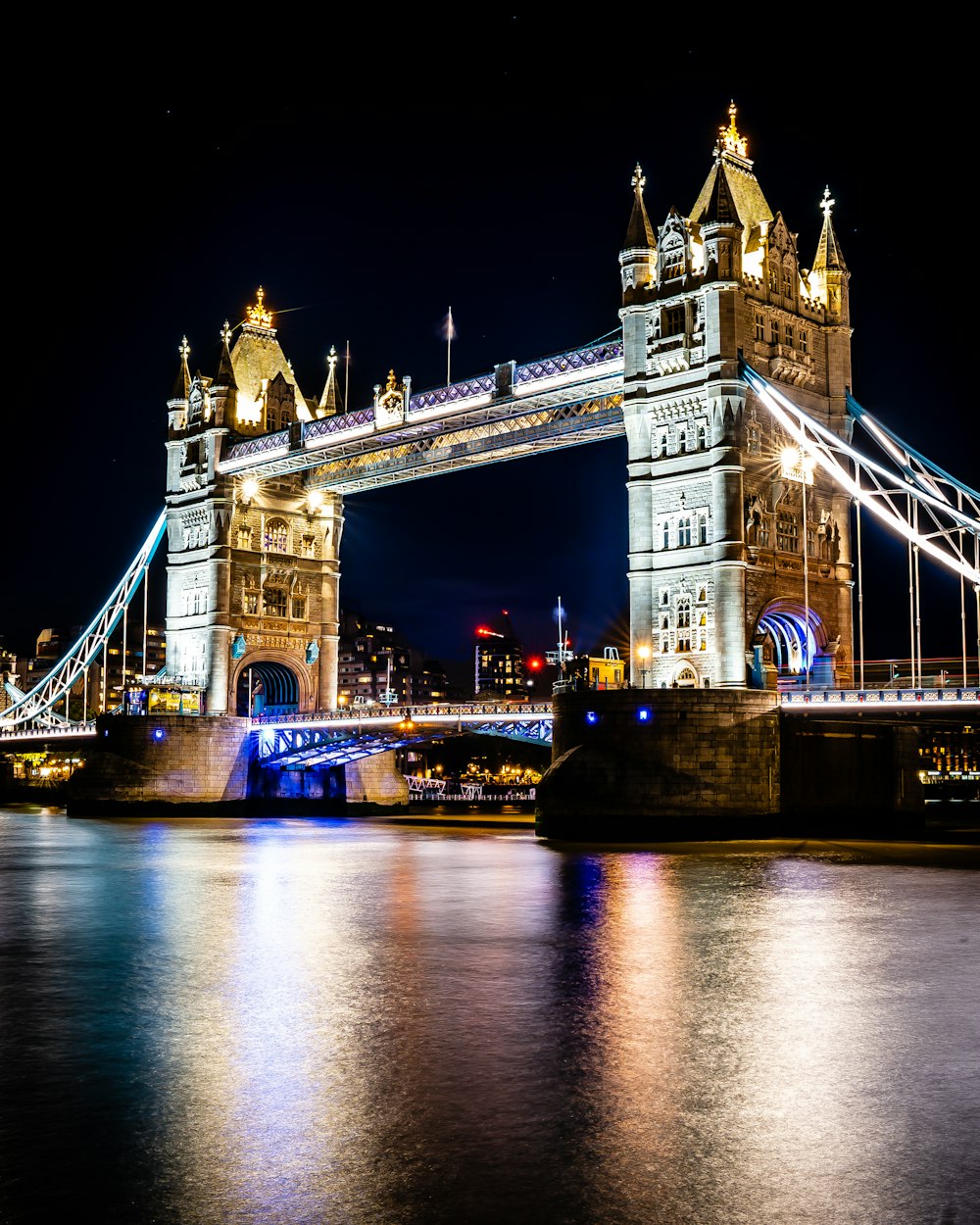 a bridge with towers and towers at night