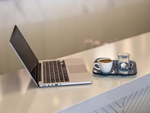a laptop and a cup of coffee