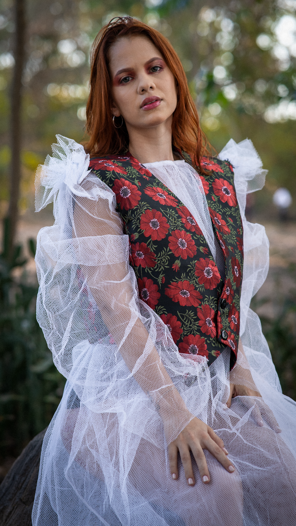 a woman with red hair wearing a white dress