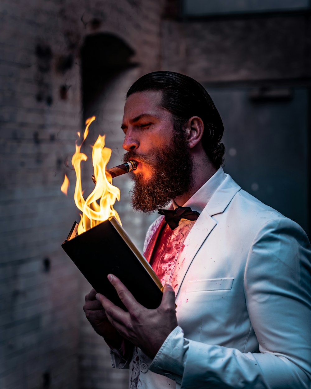 a man smoking a cigar and holding a book