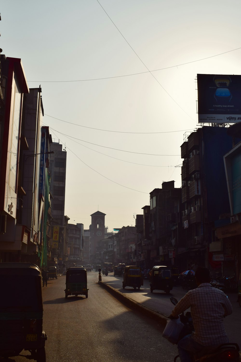 a city street with cars and people