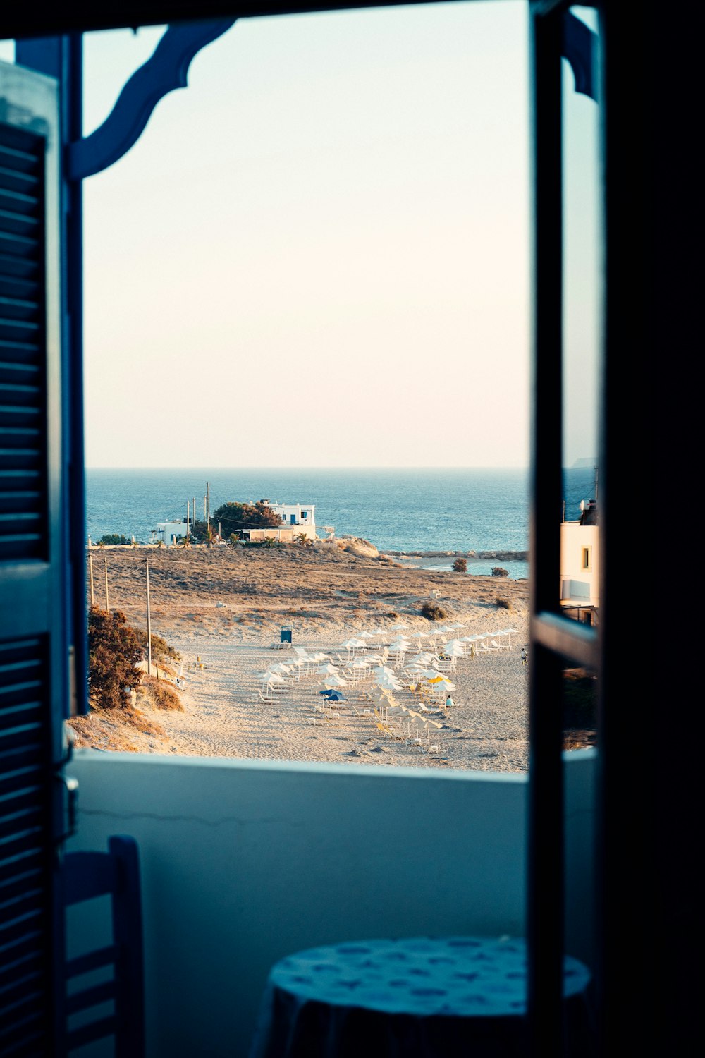 a view of a beach and ocean from a window