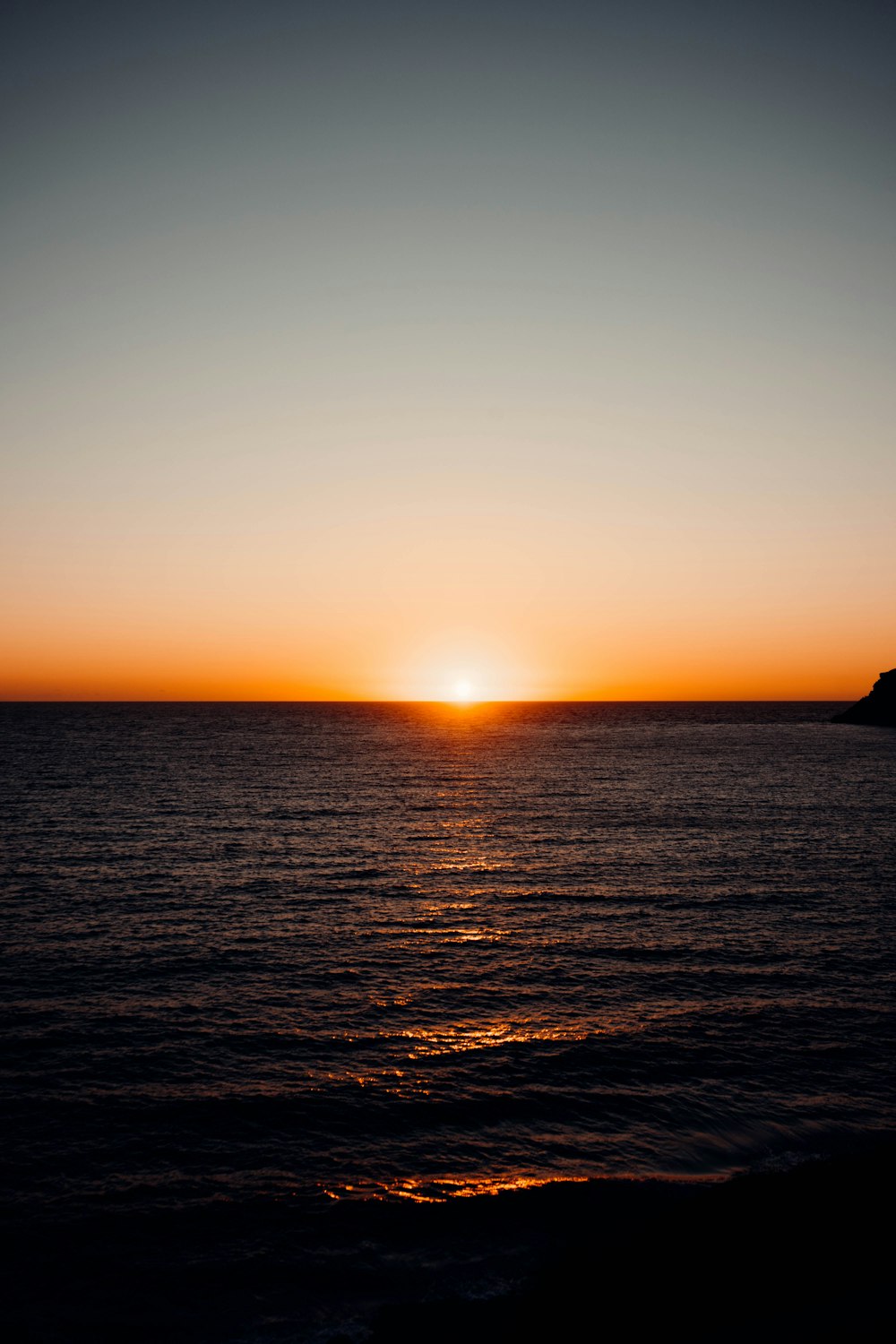 a sunset over a body of water