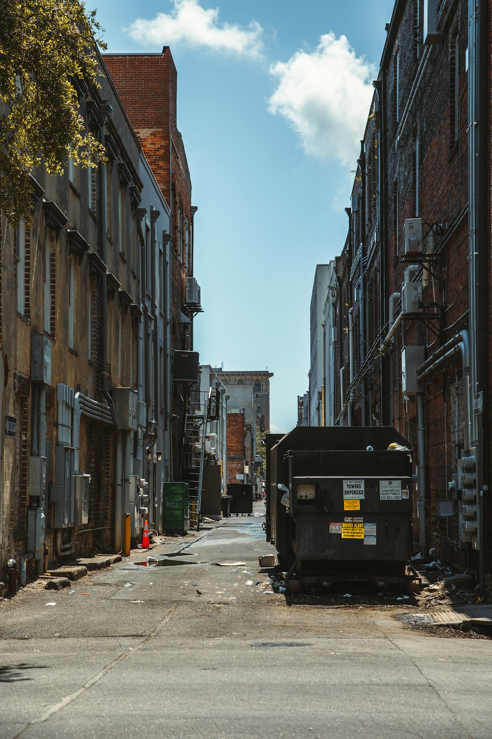 a truck parked in a street between buildings