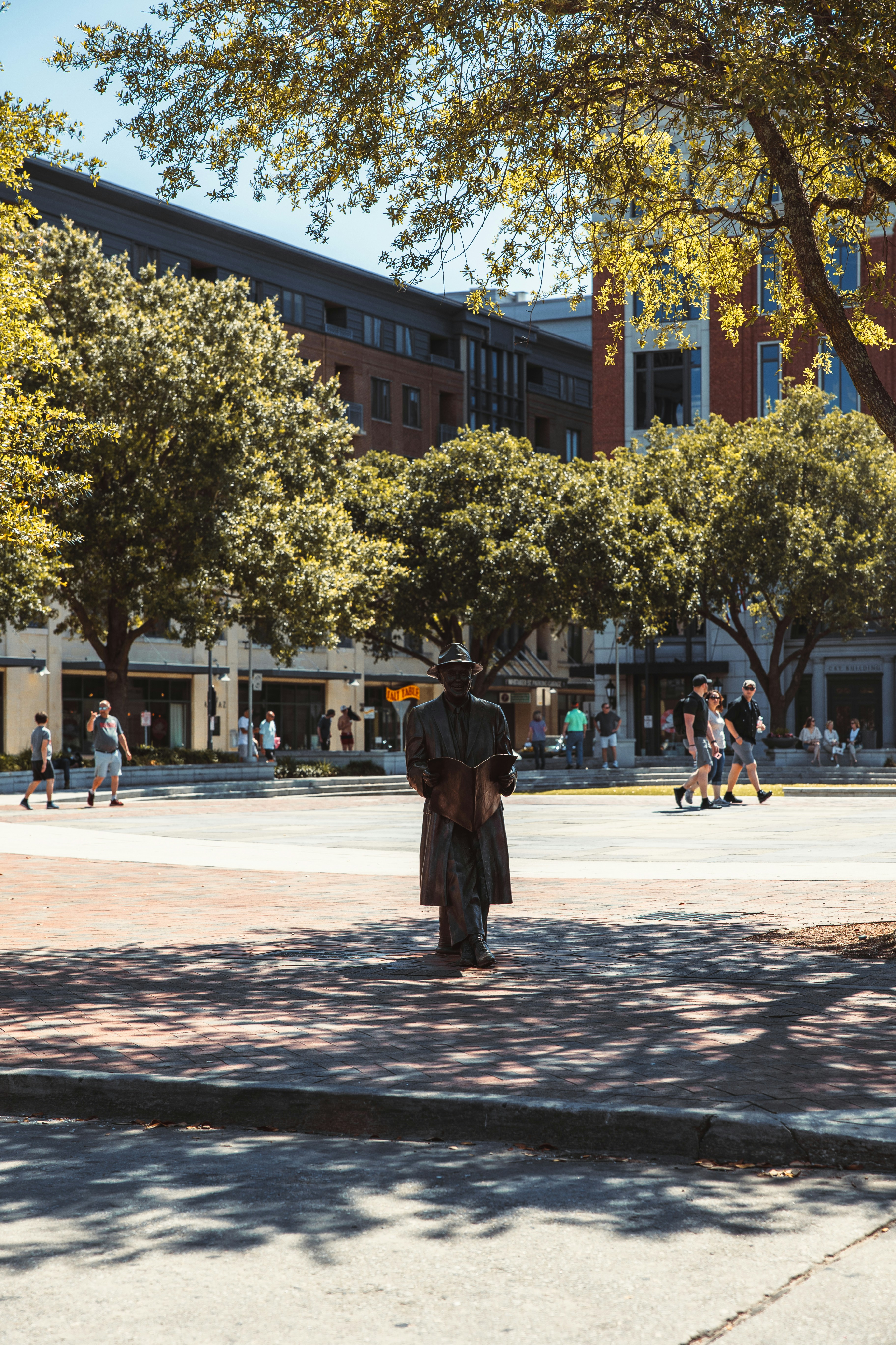 a statue of a person in a uniform on a sidewalk