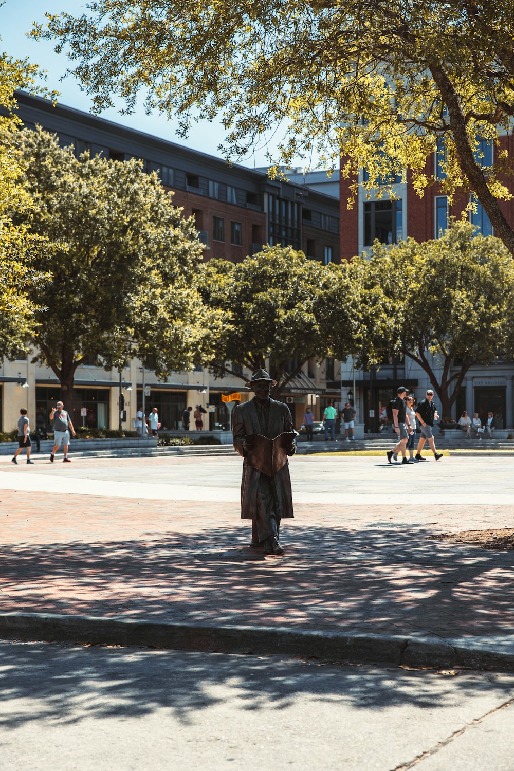 a statue of a person in a uniform on a sidewalk