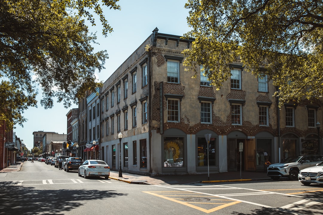 a street with cars and buildings along it,