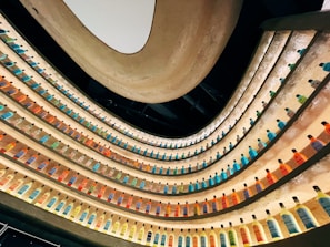 Display of beverage shelves with colorful bottles in a sleek black and lilac setting.