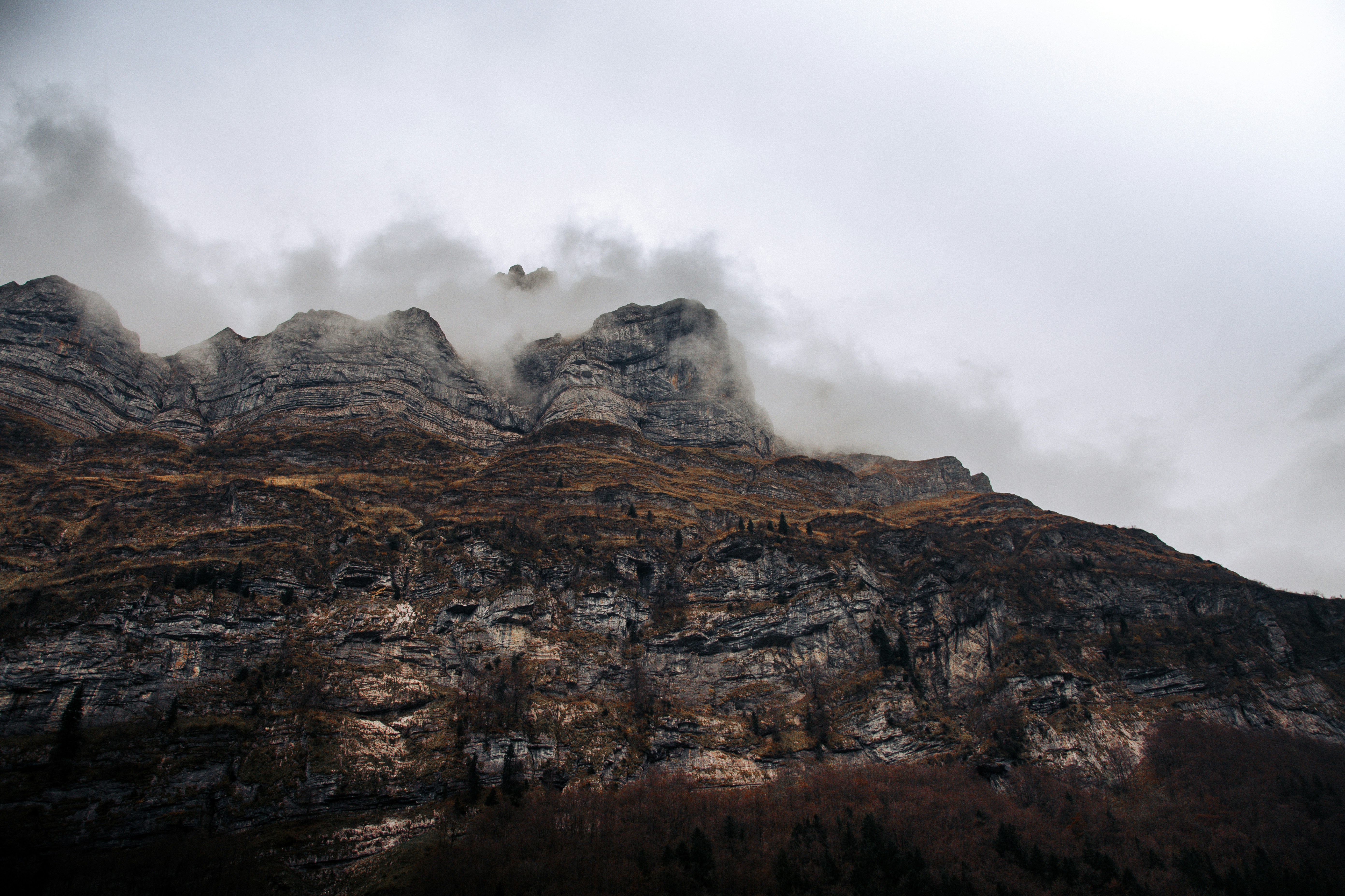 a rocky mountain with clouds